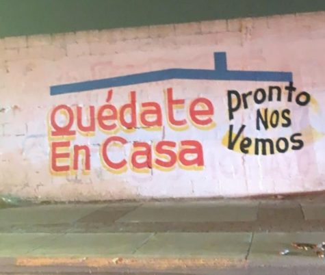 A student takes a photo of a message posted near the border crossing in Ciudad Juarez, to stay at home. 