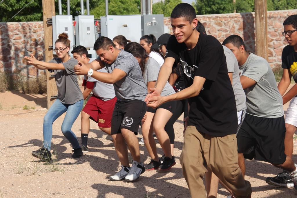 Students practice form and techniques during a law enforcement club meeting.