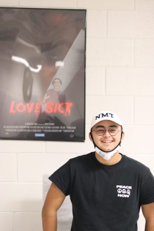 Junior Christopher Sainz stands in front of his Love Sick short film poster at Horror Fest on Nov. 3.