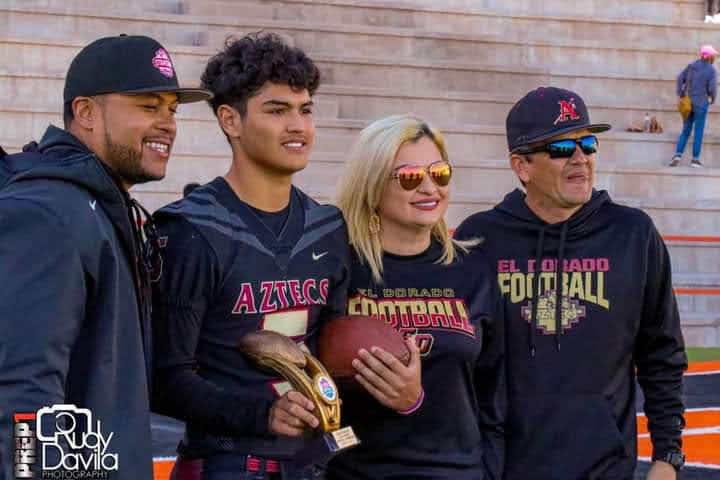 Senior Ricardo Portillo poses with his family members after winning the quarterback showcase. 
