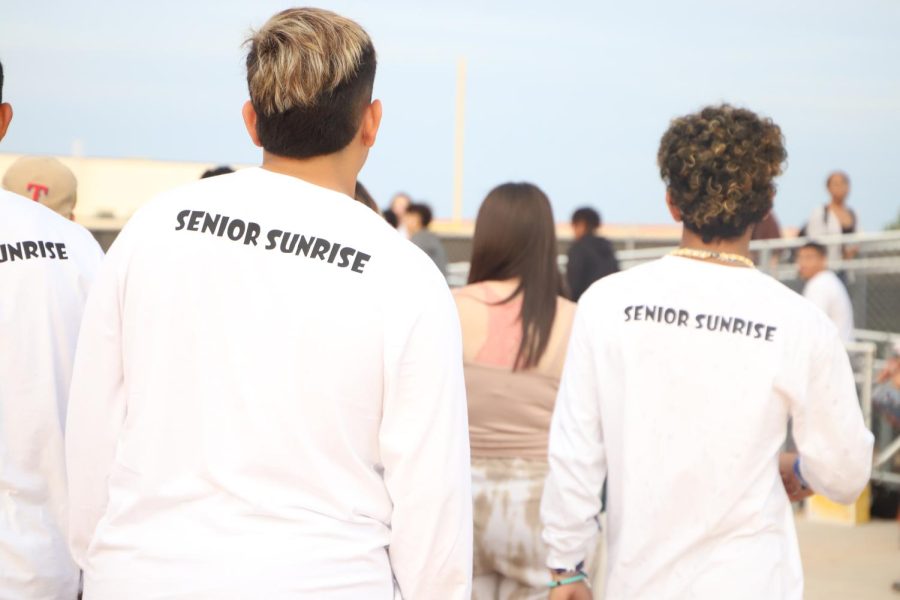 Two students look onward with their custom shirts for senior sunrise on Friday, August, 5, 2022.