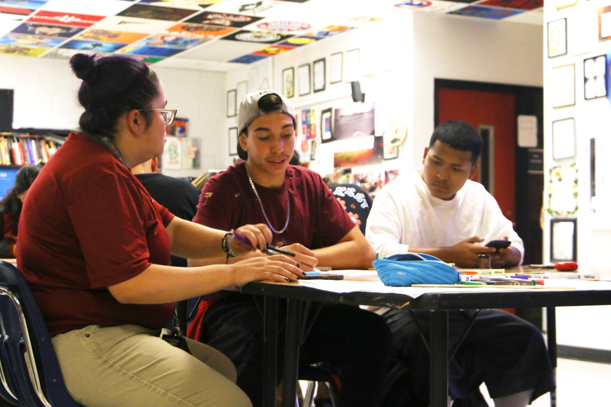 Working on techniques, senior Jesse Franco receives help from Art teacher Allison Vega on color theory notes on Aug. 19 in room D202. The two mixed primary colors and mixed them with others to understand color theory. “Something that stuck with me was how mixing colors created new colors,” Franco said. “I’ve never taken Ms. Vega’s art class before, and I hope to learn new skills.”