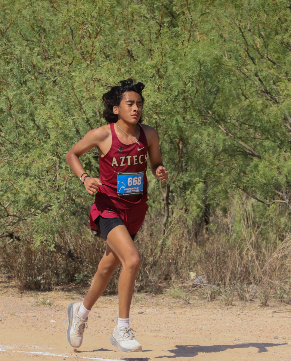 No Pain, No Gain.
Looking forward, senior Jorge Aguire runs through the desert during the Pebble Hills Invitational Meet on Aug. 10. Aguirre placed 13th in his division. “I felt exhausted at this meet,” Aguirre said. “The sun was beating down on me constantly and just draining me. Luckily, I managed to finish with a place and time I am happy with.” 