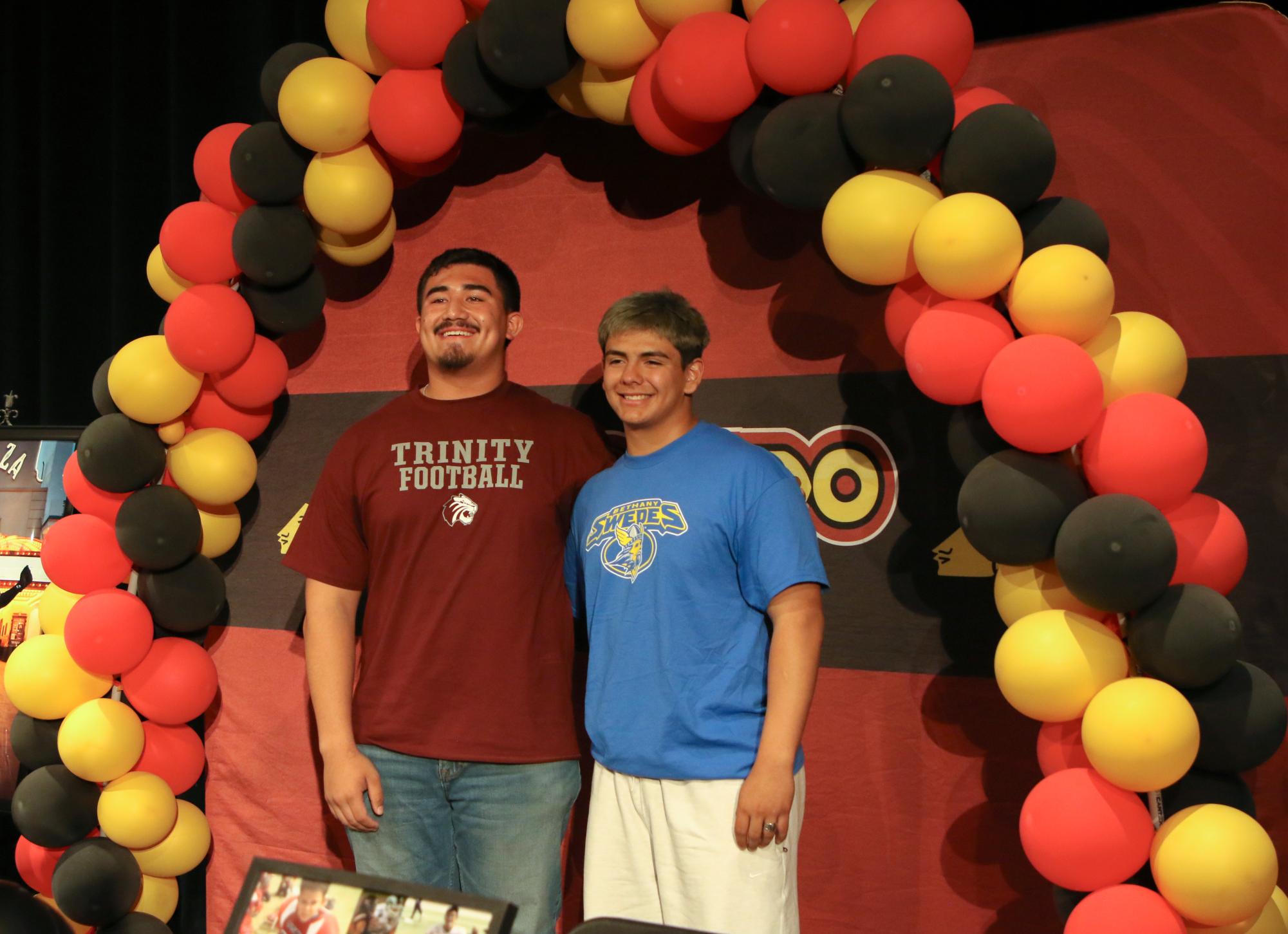 Clutch Combo. Smiling for the cameras, seniors Gabriel Terrazas and David Martinez pose for photos after their signing on April 11 in the theater. Terrazas and Martinez became friends when they were assigned to be locker buddies their sophomore year. “Gabe and I have grown a lot closer,” Martinez said. “Being with each other everyday for three years formed a bond that is nearly unbreakable.” 