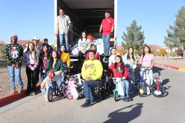 Posing for a photo, Student Council members smile with the Aztec Angel donations on Dec. 11 at El Dorado High School. During the process, senior Mia Luna found the moment heartwarming. “Loading up the truck with the gifts felt really rewarding because I finally got to see the vast amount of gifts the school was able to donate to families who are in an unfortunate situation during the holidays," Luna said.